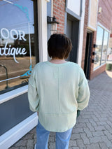 Split Neck Raw Edge Long Sleeve Ribbed Top