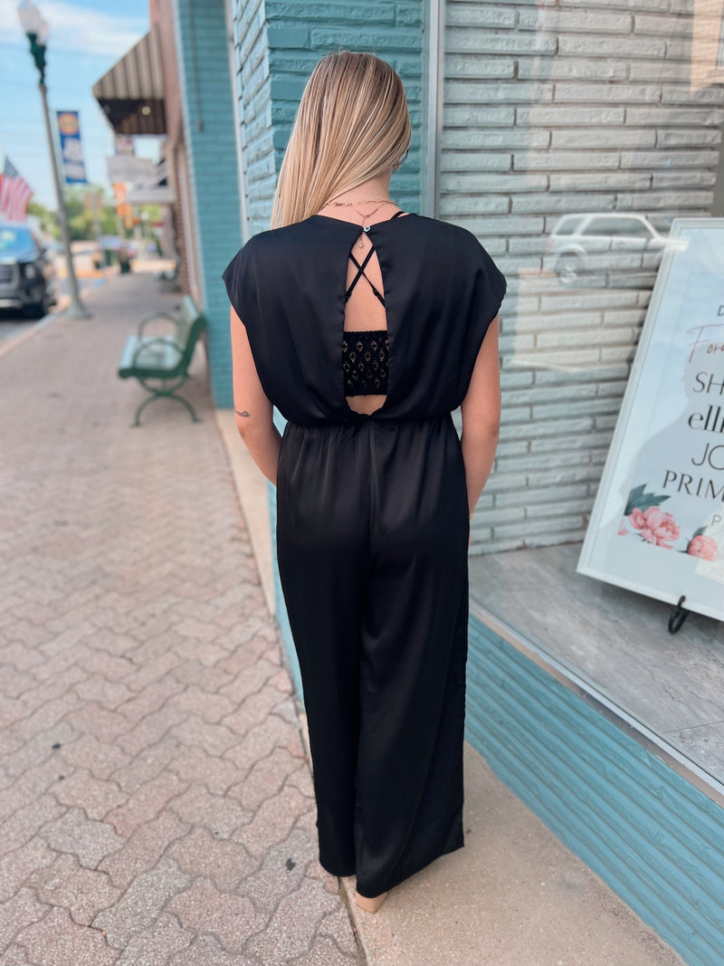 Black silk romper with knot detail