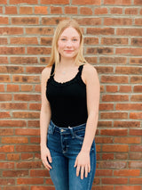 Black ribbed bodysuit with ruffle shoulder